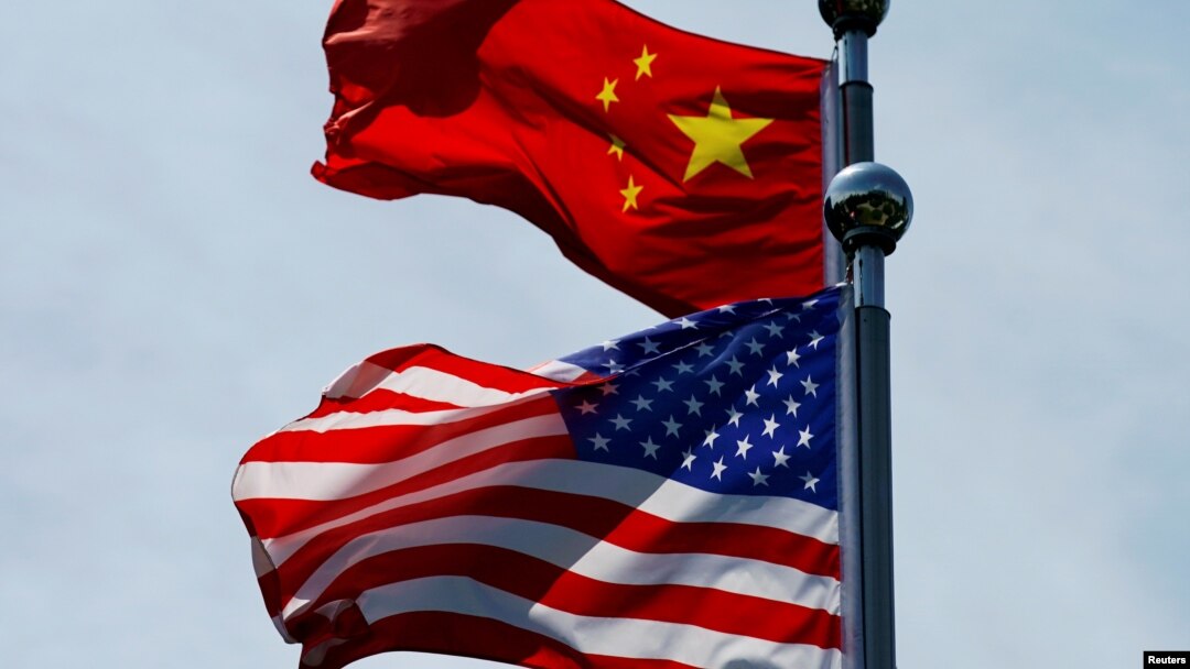FILE - A Chinese and U.S. flag flutter near The Bund, before U.S. trade representatives meet with their Chinese counterparts for talks in Shanghai, China, July 30, 2019.