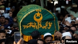 FILE - Supporters carry the coffin of Ko Ni, a prominent member of Myanmar's Muslim minority and legal adviser for Myanmar's ruling National League for Democracy, in Yangon, Myanmar, Jan. 30, 2017.