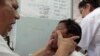 FILE - A dengue fever victim receives medical treatment at a health center in Managua, Nicaragua, Oct. 31, 2013. 