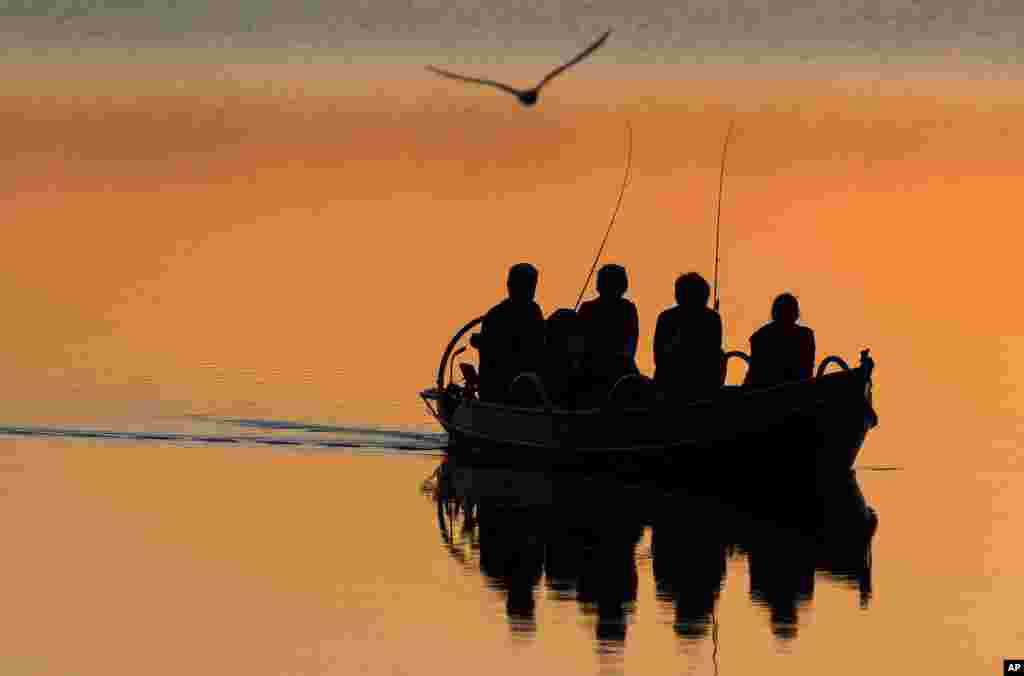 Local men fish in a boat on the Lusiai lake near the small town of Ignalina, some 120km (74,5 miles) north of the capital Vilnius, Lithuania, June 3, 2019.