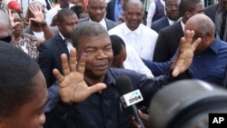 FILE - Angola's MPLA main ruling party candidate and Defense Minister Joao Lourenco, shows his ink-stained finger as he faces the media after casting his vote in elections in Luanda, Angola.