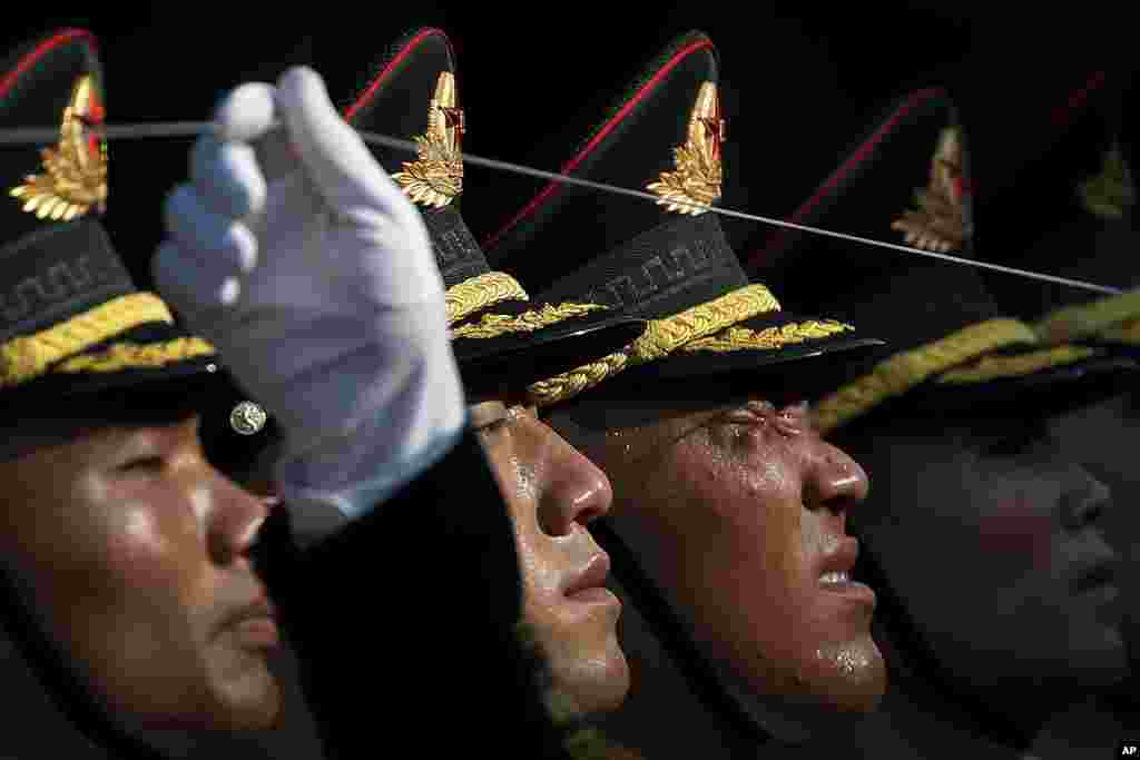A member of an honor guard reacts as he and his comrades prepare for a welcome ceremony for visiting Colombia's President Ivan Duque, at the Great Hall of the People in Beijing, China.