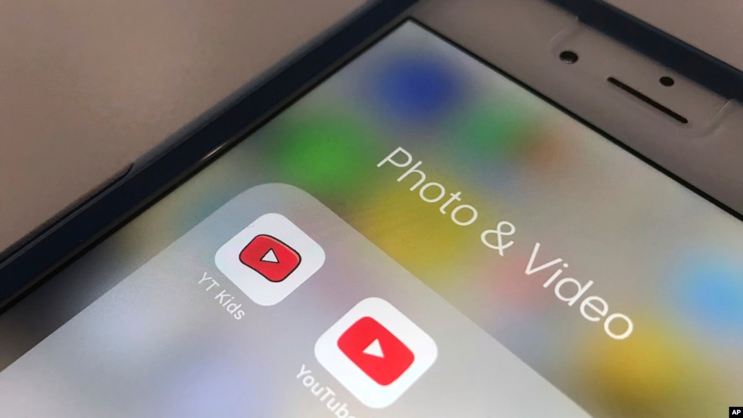 FILE - The YouTube app and YouTube Kids app are displayed on an iPhone in New York, April 25, 2018. 