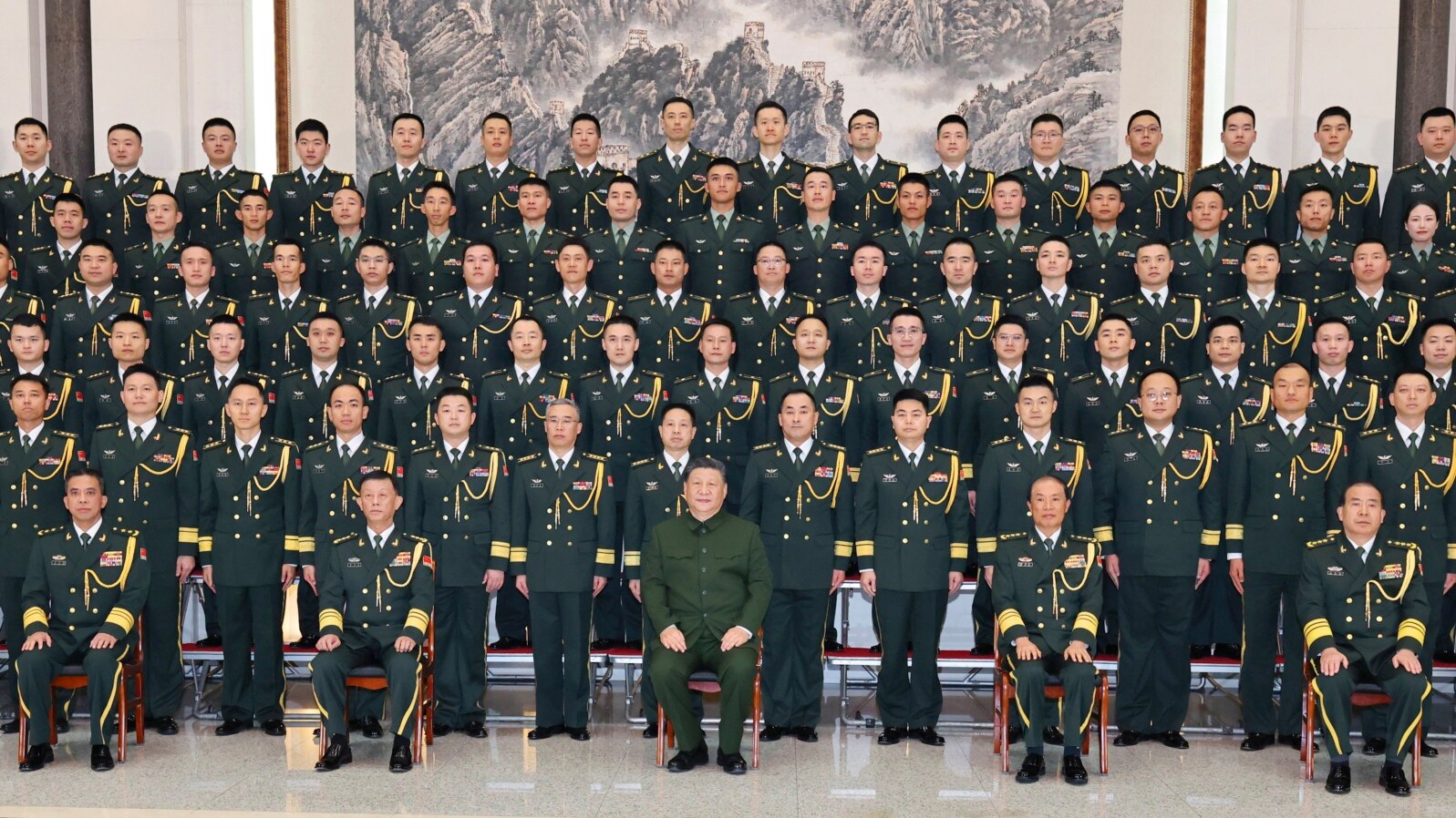 In this photo released by Xinhua News Agency, Chinese President Xi Jinping poses for photos with military personnel of the Chinese People's Liberation Army garrison stationed in the Macao Special Administrative Region in southern China, Dec. 20, 2024. (Li Gang/Xinhua via AP)
