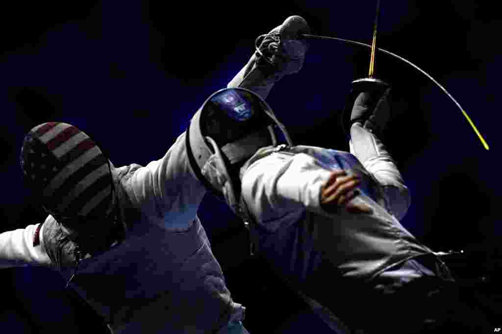 Tamas Meszaros (R) of Hungary and Race Imboden of United States fence during the men's team foil round of 16 match of the FIE World Fencing Championships in Budapest, Hungary.