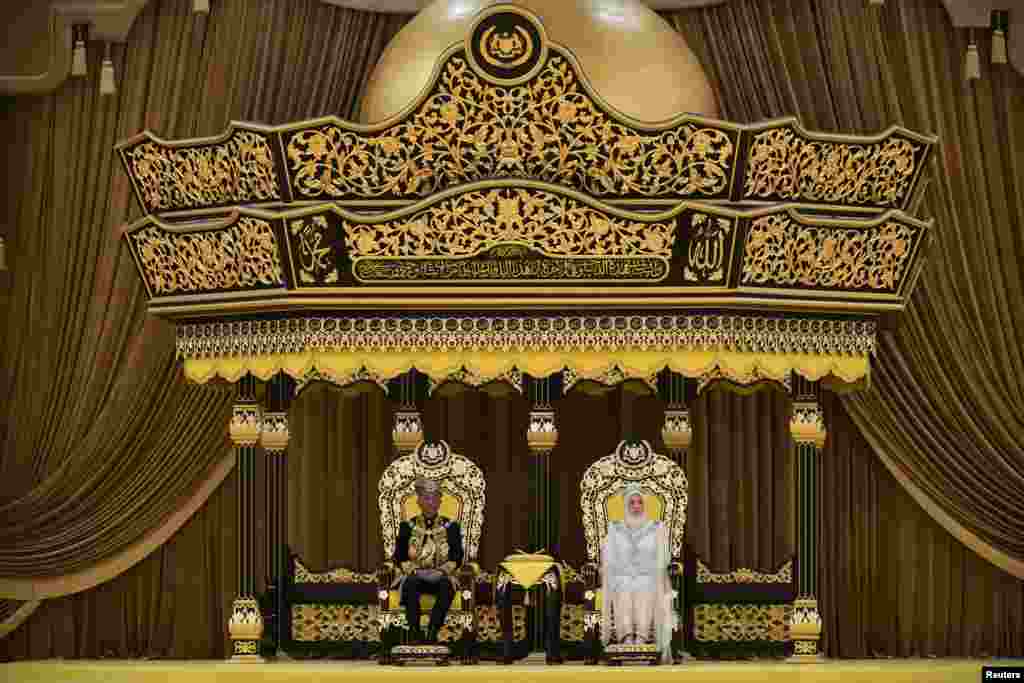 Malaysia's new King Al-Sultan Abdullah Ri'ayatuddin Al-Mustafa Billah Shah and Queen Tunku Azizah Aminah Maimunah sit during the coronation ceremony at the National Palace in Kuala Lumpur. (Credit: Nazri Rapaai/Malaysia's Department of Information/Handout)