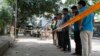 Bangladeshi police and detectives stand by the site where Italian citizen Cesare Tavella was gunned down by unidentified assailants in Dhaka, Sept. 29, 2015.