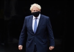 FILE - Britain's Prime Minister Boris Johnson visits the headquarters of Octopus Energy in London, Oct. 5, 2020.