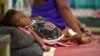 An infant lies in bed in a malnutrition intensive care unit in Dharbhanga, India, April 16, 2015. Researchers thought stunting was mostly caused by malnutrition, but a study indicates a parasite may be a factor.