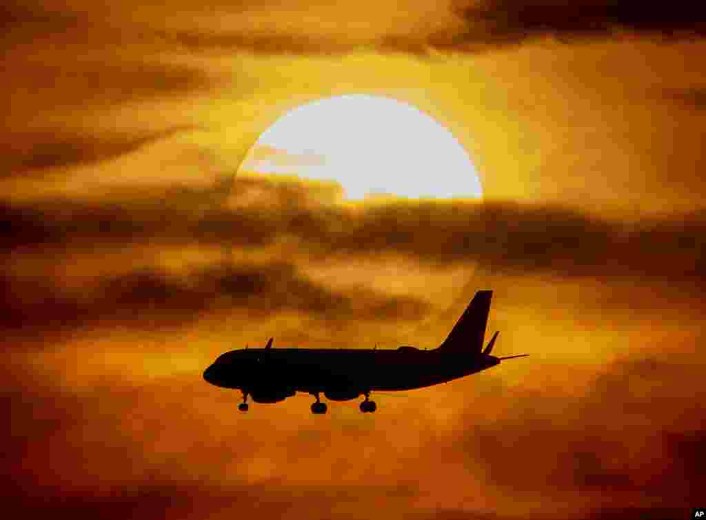 An aircraft approaches the airport as the sun sets in Frankfurt, Germany, June 15, 2019.