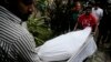 The body of Italian citizen Cesare Tavella, who was gunned down by unidentified assailants, is carried out of a hospital morgue in Dhaka, Bangladesh, Oct. 14, 2015. 