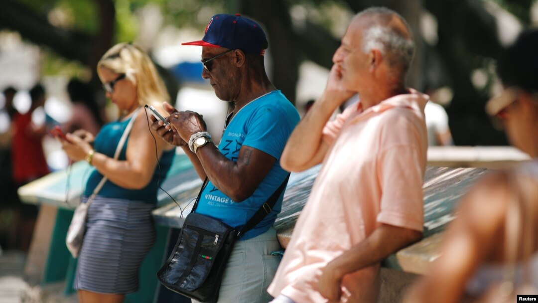 Cubans check their phones at an internet hotspot in Havana, Cuba, Aug. 10, 2018. A day of free, expanded internet was provided by the state-run telecommunications company, Aug. 14, 2018.