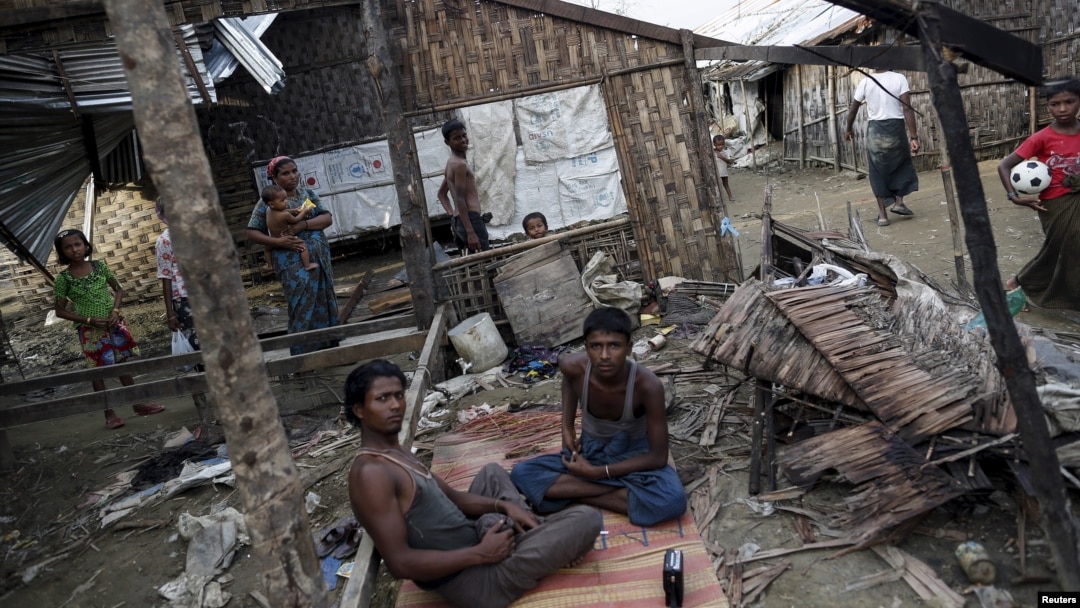 FILE - Rohingya people pass their time in a damaged shelter in Rohingya IDP camp outside Sittwe, Rakhine state, Aug. 4, 2015. Kerry noted the Rohingya as a group that has been 'singled out' for discrimination.