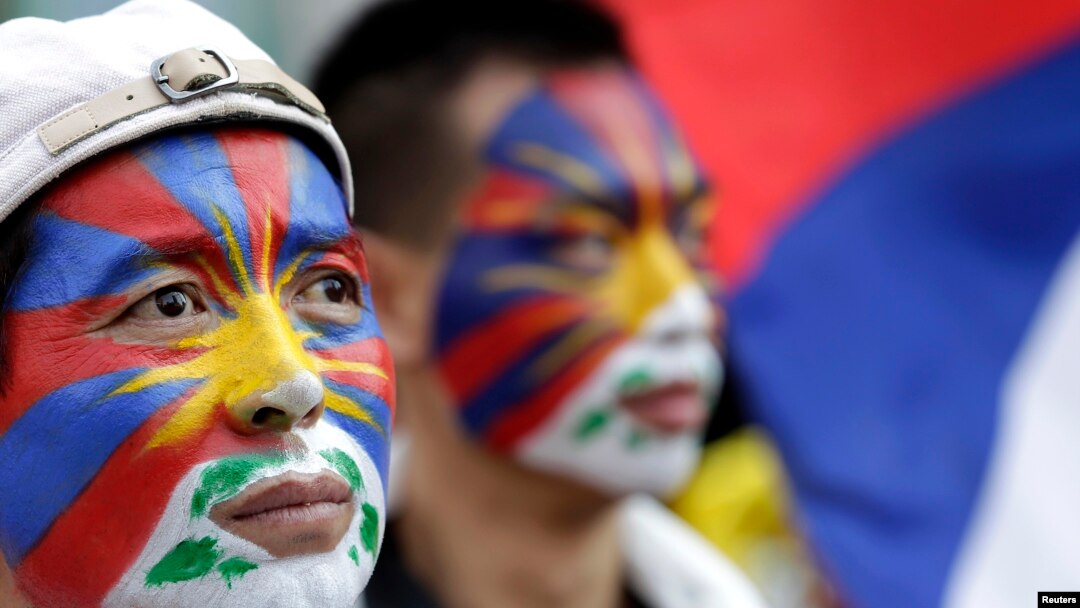 Activists with the colors of the Tibetan flag painted on their faces are seen at a rally in Taipei March 10, 2013.