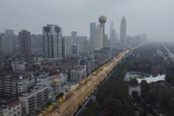 An aerial view shows residential and commercial buildings of Wuhan in China's central Hubei province on January 27, 2020.