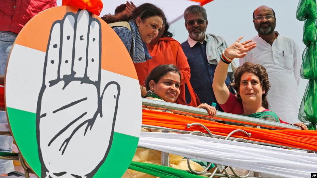 Congress party General Secretary and eastern Uttar Pradesh state in-charge Priyanka Gandhi Vadra, right, waves to party workers as she undertakes a steamer ride in the River Ganges from Manaiya, 25 kilometers (15.6 miles) from Prayagraj, India, March 18, 2019.