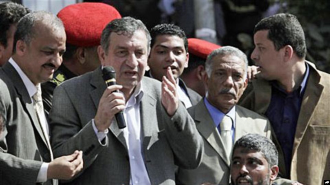 Egyptian PM-designate Essam Sharaf, with microphone, speaks to demonstrators in Tahrir Square in Cairo, March 4 2011