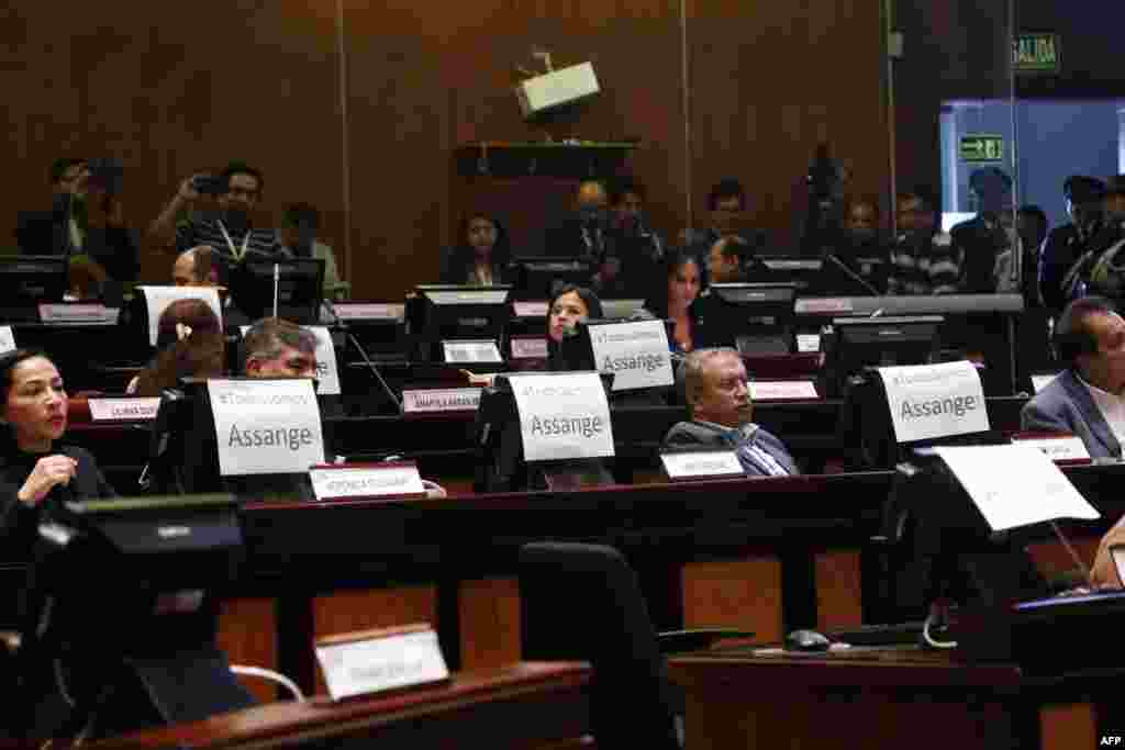Members of the Ecuadorean National Assembly show signs that read "We are all Assange" as Ecuadorean Minister of Foreign Affairs Jose Valencia (out of frame) speaks in Quito. President Lenin Moreno's government withdrew the Ecuadoran citizenship that had been granted to WikiLeaks founder Julian Assange before his arrest in London, Foreign Minister Jose Valencia said.