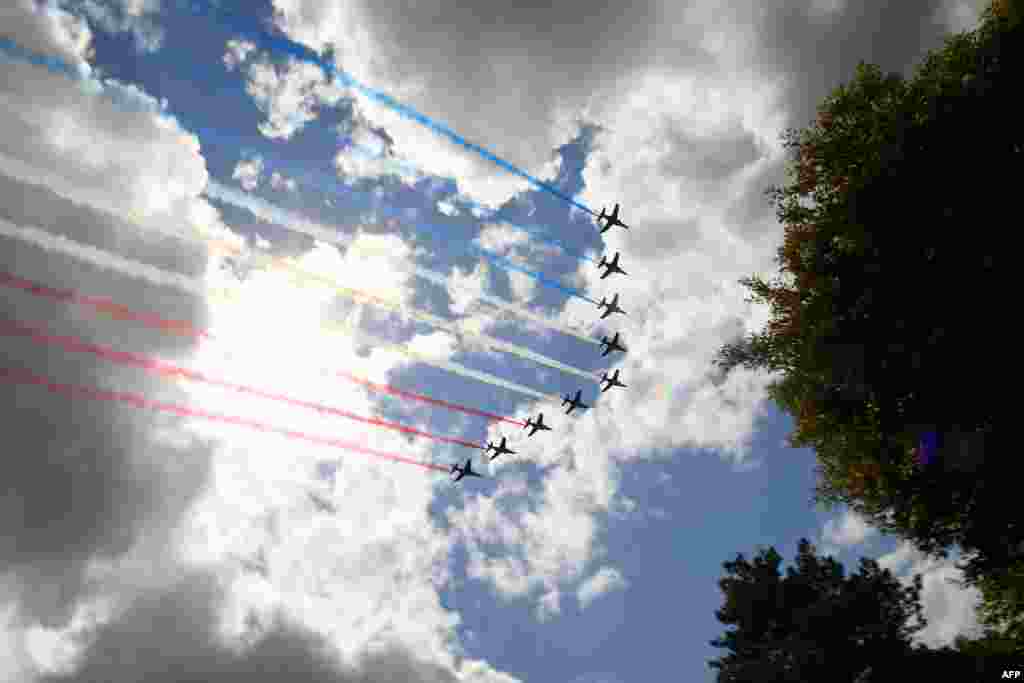 French elite acrobatic flying team 'Patrouille de France' (PAF) perform over the Normandy American Cemetery in Colleville-sur-Mer in Normandy, northwestern France, at the end of a French-US ceremony as part of D-Day commemorations marking the 75th anniversary of the World War II Allied landings in Normandy.