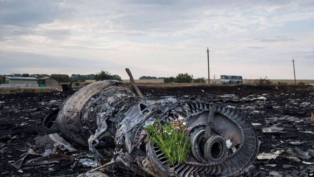 Flowers are placed on a plane engine at the crash site of a Malaysia Airlines jet near the village of Hrabove, eastern Ukraine, July 19, 2014.
