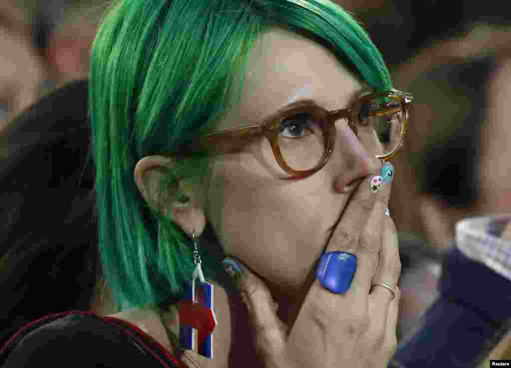 A supporter of U.S. Democratic presidential nominee Hillary Clinton watches results at her election night rally in Manhattan, New York, Nov. 8, 2016.