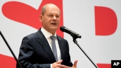Olaf Scholz, top candidate for chancellor of the Social Democratic Party (SPD), speaks during a press conference at the party's headquarters in Berlin, Germany, Sept. 27, 2021. (AP Photo/Michael Sohn)