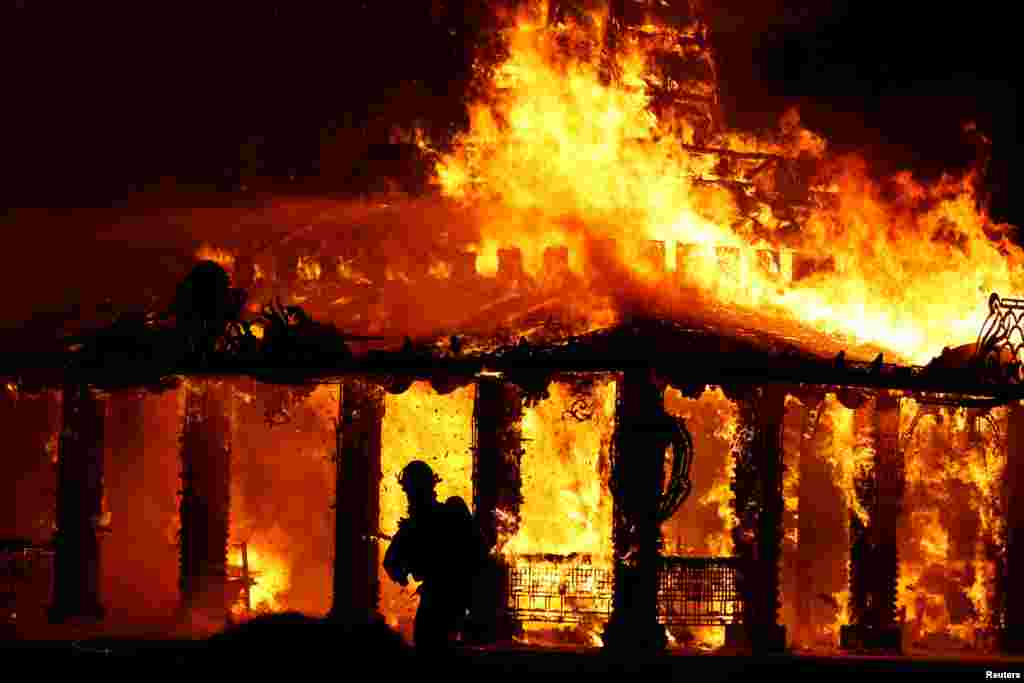The 'Temple of Time', a structure built to serve as a healing place for those affected by the shooting at nearby Marjory Stoneman Douglas High School, is burned in a ceremonial fire in Coral Springs, Florida, May 19, 2019.