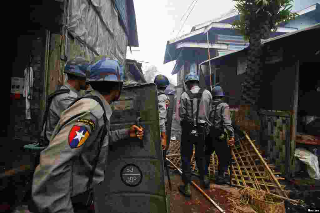 Cảnh sát tiến đến những ngôi nhà bị cháy trong vụ xung đột tại Sittwe, 10/6/2012.