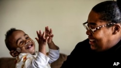 FILE - Curtis Means plays with his mother, Michelle Butler, at their home in Eutaw, Alabama, March 23, 2022. After his premature birth, Curtis stayed in the newborn intensive care unit for nine months. A study published Oct. 6, 2023, says 1 in 10 babies worldwide are premature.