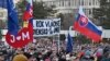 People gather in Bratislava, Slovakia on Feb. 21, 2025, to mark the seventh anniversary of the slayings of an investigative journalist, Jan Kuciak, and his fiancee, Martina Kusnirova. (Vaclav Salek/CTK via AP)