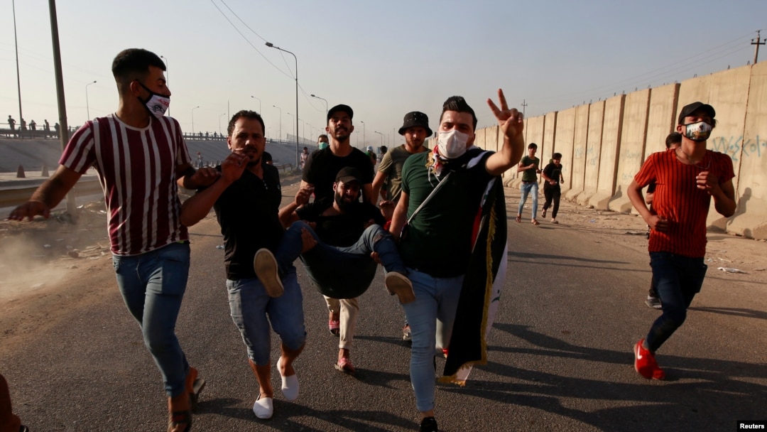 Men carry an injured demonstrator during a nationwide anti-government protests in Baghdad, Iraq, Oct. 3, 2019.