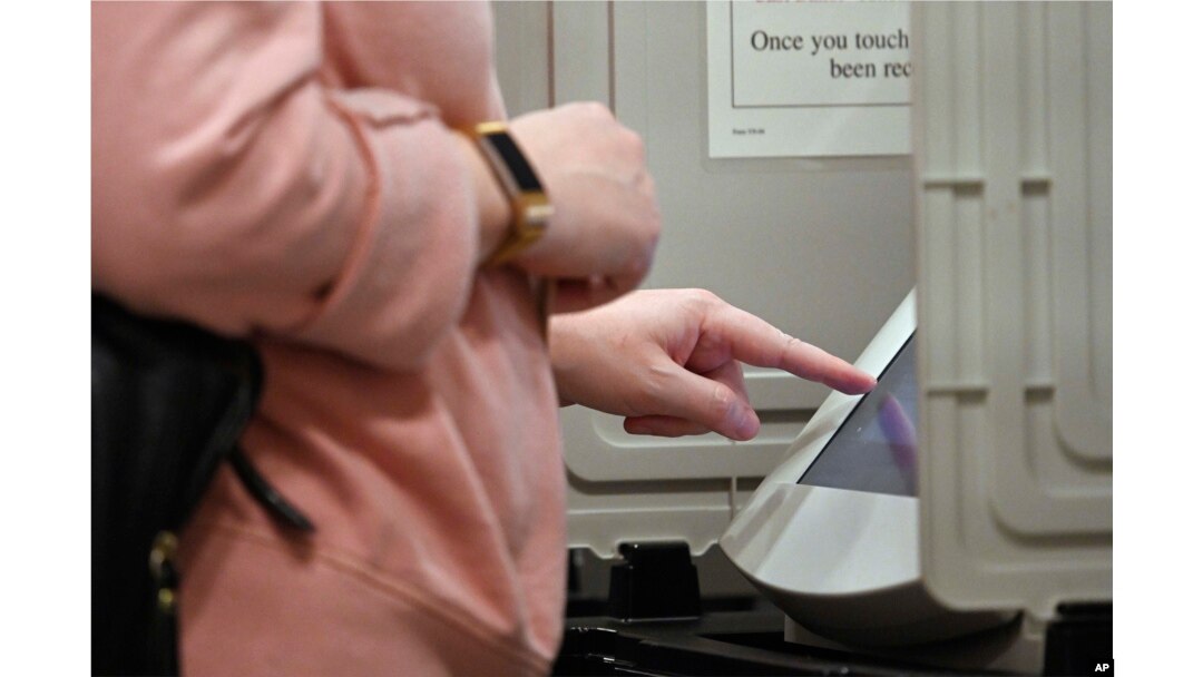 A woman casts her ballot ahead of the Nov. 6 general election at Jim Miller Park, Oct. 27, 2018, in Marietta, Ga.