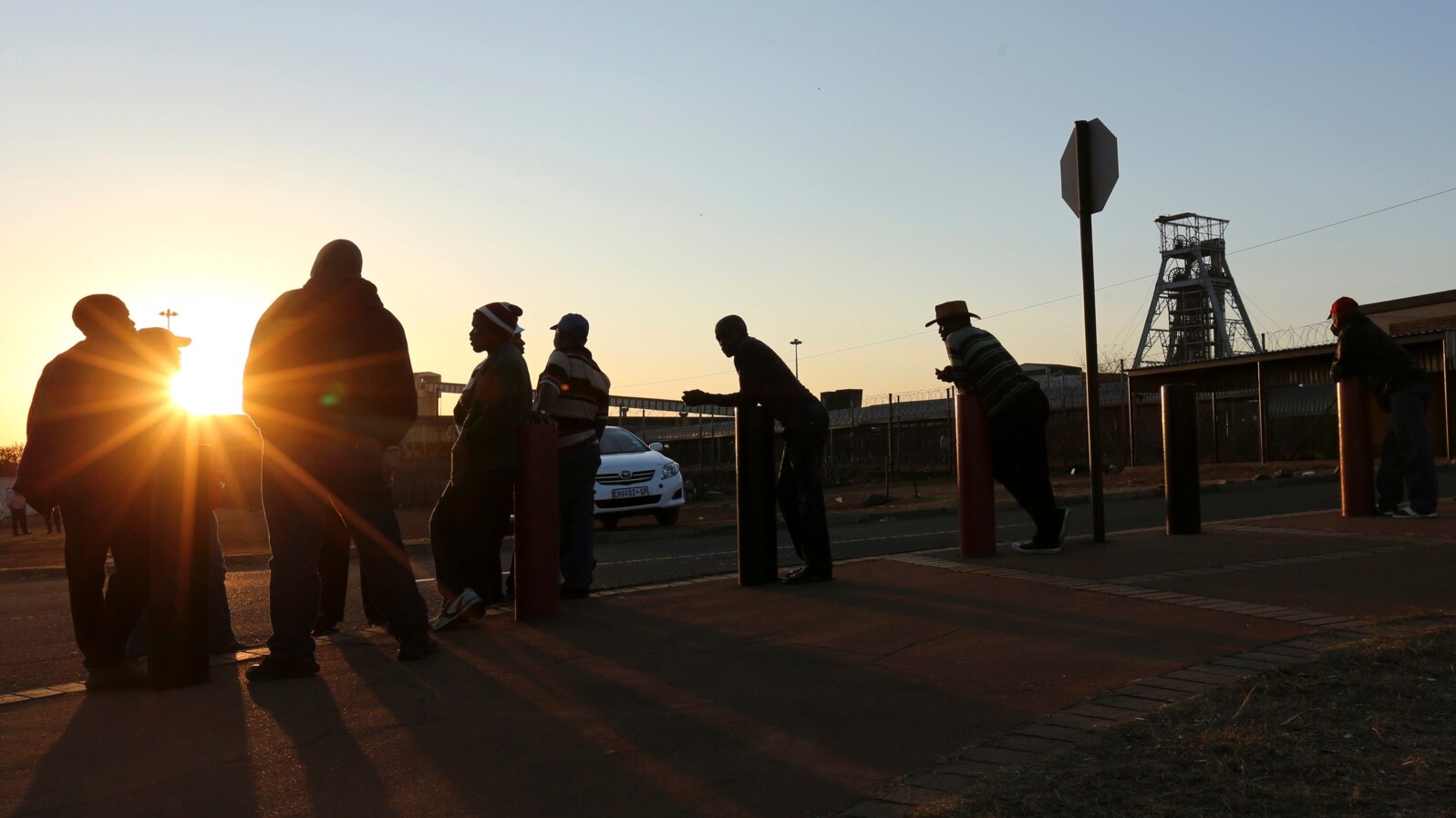Mine workers await their shift outside the Doornkop Gold Mine, about 30 kilometers west of Johannesburg, Sept. 3, 2013.