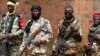 Seleka fighters warily eye a photographer at their base in Bambari, Central African Republic, on May 31, 2014. 