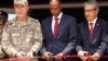 Turkish Chief of Staff General Hulusi Akar, left, Somali prime minister Hassan Ali Khayre, center, and Turkish Ambassador to Somalia Olgan Bekar cut a ribbon to open the Turkey-Somali military training center in Mogadishu, Sept. 30, 2017. 