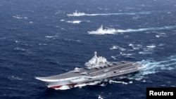 FILE - China's Liaoning aircraft carrier with accompanying fleet conducts a drill in an area of the South China Sea, in this photo taken in December 2016. 