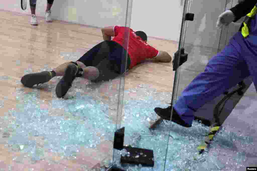 Mexico's Alvaro Beltran lies on the court after shattering a glass panel of the racquetball court during his Gold Medal Match against Rodrigo Montoya, also of Mexico, at the Pan American Games in Lima, Peru, Aug. 7, 2019.