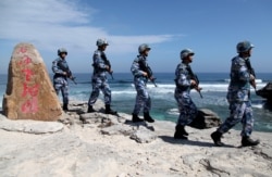 Soldiers of China's People's Liberation Army (PLA) Navy patrol on Woody Island, in the Paracel Archipelago, which is known in China as the Xisha Islands, on January 29, 2016. (Reuters)