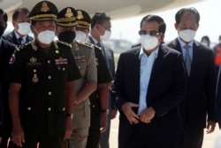 Cambodian Prime Minister Hun Sen, second from right, walks at Phnom Penh International Airport after returning from Myanmar on January 8, 2022. (Heng Sinith/AP)
