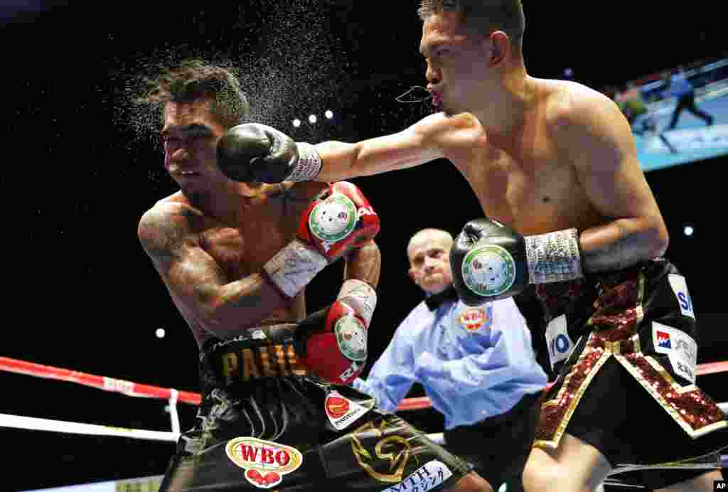Japan's Kazuto Ioka, right, sends a right to Philippines' Aston Palikute in the 10th round of their WBO super flyweight boxing title match in Makuhari, near Tokyo, Japan.