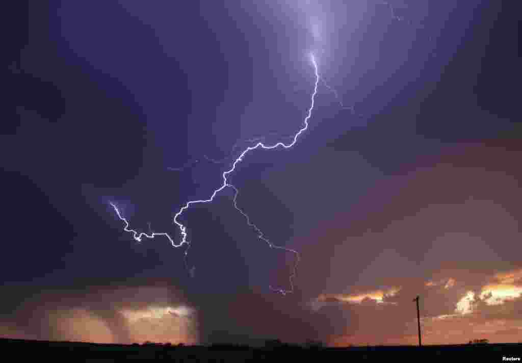 Huge lightning strikes cross the skies as thunderstorm supercells pass through areas in Archer City, Texas, April 23, 2014.