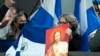 Partidarios de los presos políticos nicaragüenses cantan en el Aeropuerto Internacional Washington Dulles, en Chantilly, Virginia, el jueves 9 de febrero de 2023. (Foto AP/José Luis Magaña)