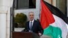 Palestinian Prime Minister Rami Hamdallah talks to media after the first unity government meeting in the West Bank city of Ramallah, June 3, 2014.