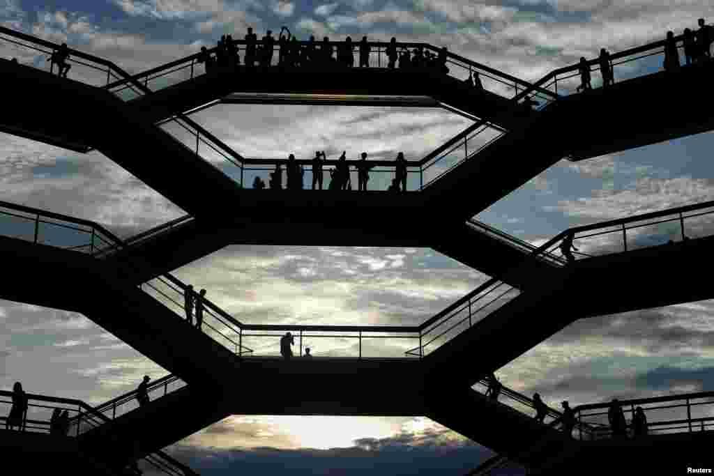 People tour inside 'The Vessel,' a large public art sculpture made up of 155 flights of stairs at the Hudson Yards development - a residential, commercial, and retail space - on Manhattan's West side in New York City, May 26, 2019.