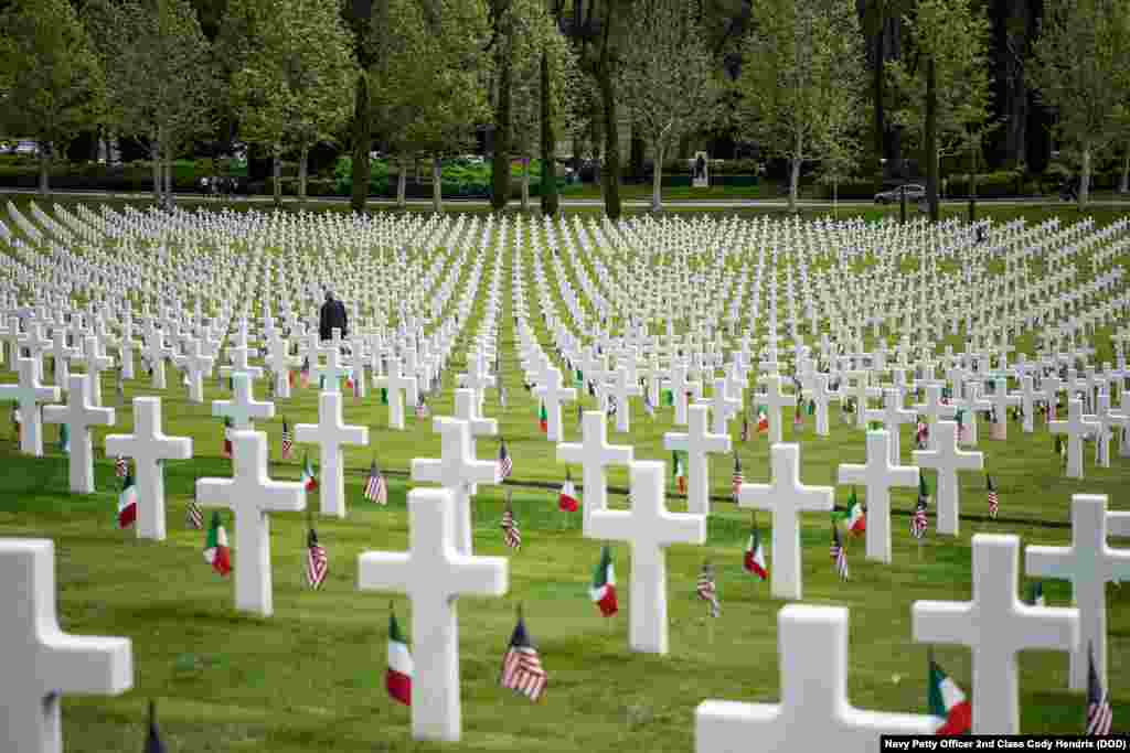 A man walks among the 4,398 tombstones at the Florence American Cemetery during a Memorial Day ceremony, Florence, Italy, May 27, 2019.