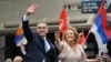Uruguay's incoming President Yamandu Orsi and Vice President Carolina Cosse wave as they ride in an open car on Inauguration Day, in Montevideo, March 1, 2025. 