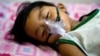 A boy with dengue fever receives medical oxygen while laying on a bed at the Quirino hospital in Quezon city in the suburbs of Manila, August 14, 2012.