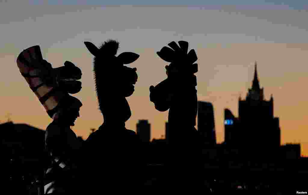 People dressed in costumes of zebras gather at a bridge in central Moscow, Russia.