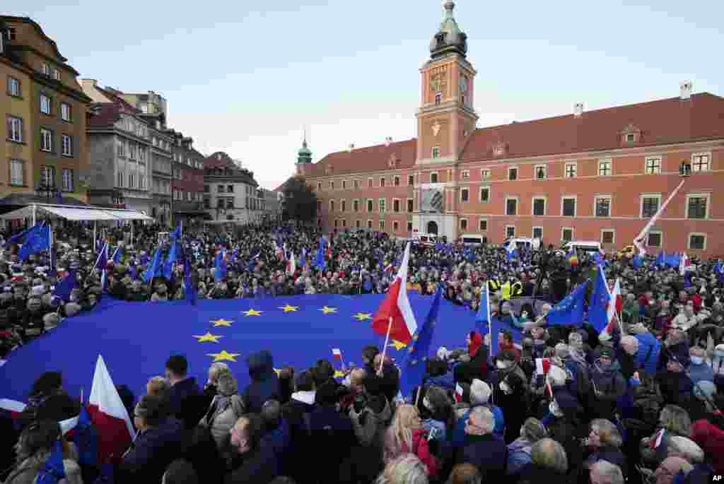 People wave EU and Polish flags in support of Poland's EU membership during a demonstration, in Warsaw, Poland.