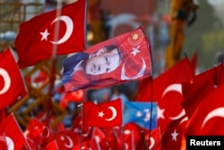A flag with the picture of Turkey's President Tayyip Erdogan is featured during the Democracy and Martyrs Rally, organized by Erdogan and the ruling AK Party in Istanbul, Aug. 7, 2016.